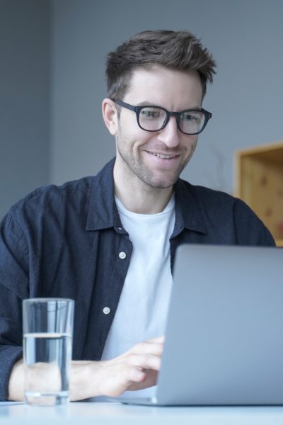 young-smiling-businessman-european-financial-consultant-working-remotely-online-from-home-office.jpg